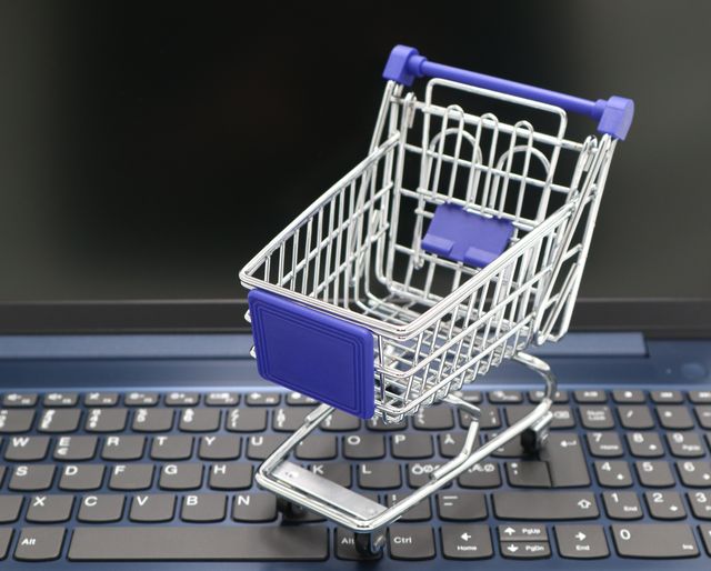 tiny shopping cart set on laptop keyboard